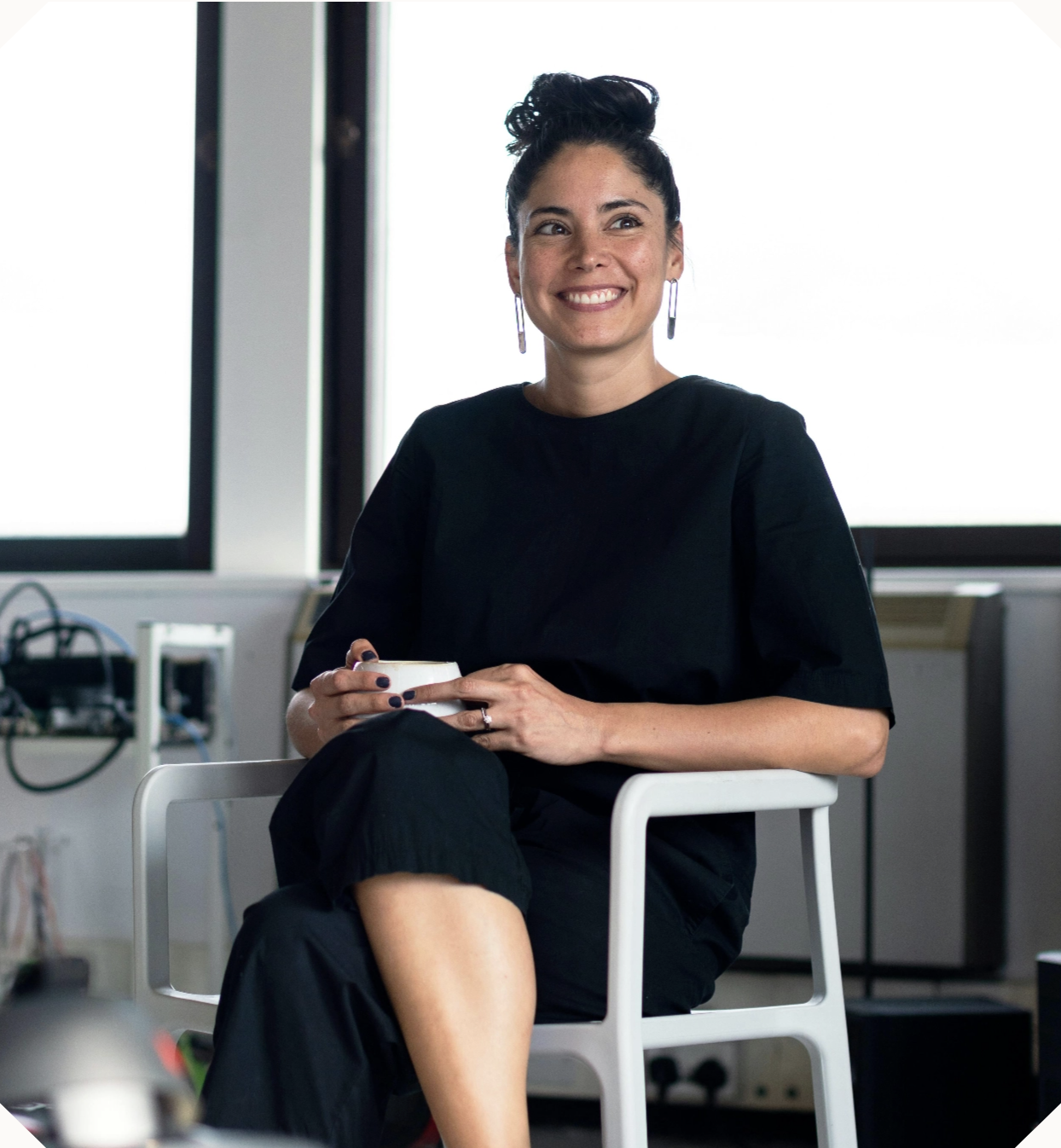 A woman in an office with coffee